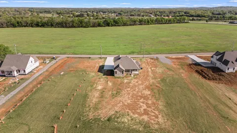 an aerial view of a residential houses with outdoor space and river