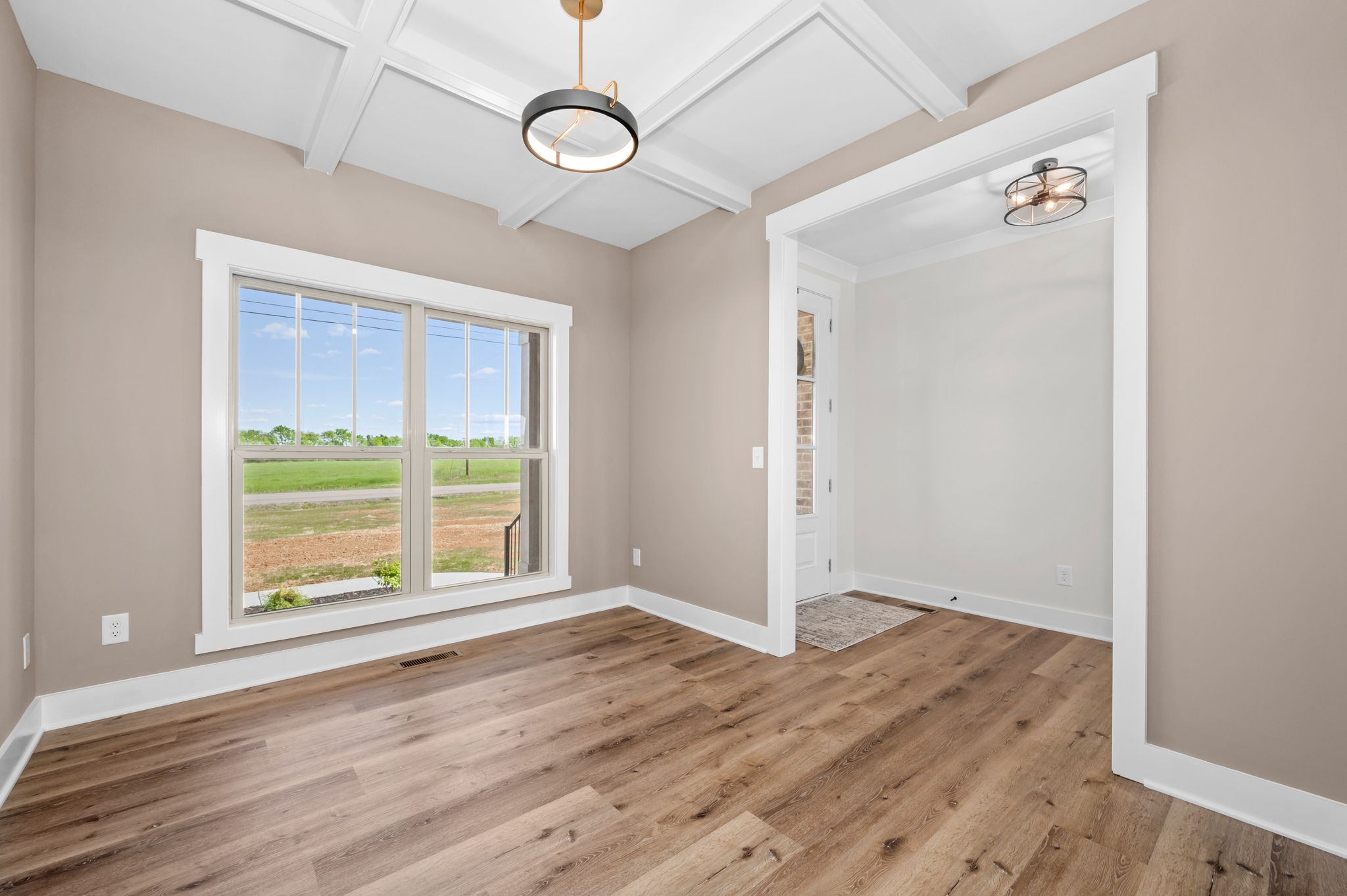7254 West Gum Road Murfreesboro, TN 37127 - Photo 9 of 58 an empty room with wooden floor fan and windows