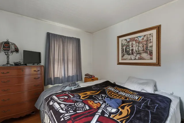 a bedroom with a bed and a window