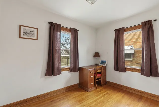 a view of a hallway with wooden floor and closet
