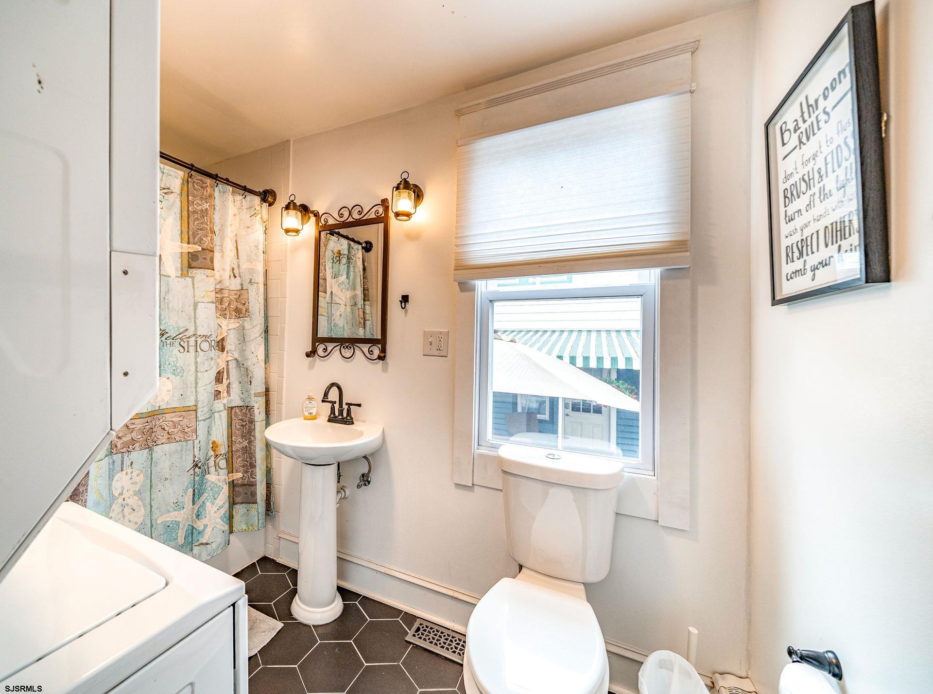 321 Central Avenue Ocean City, NJ 08226 - Photo 13 of 61 a bathroom with a sink a toilet and shower