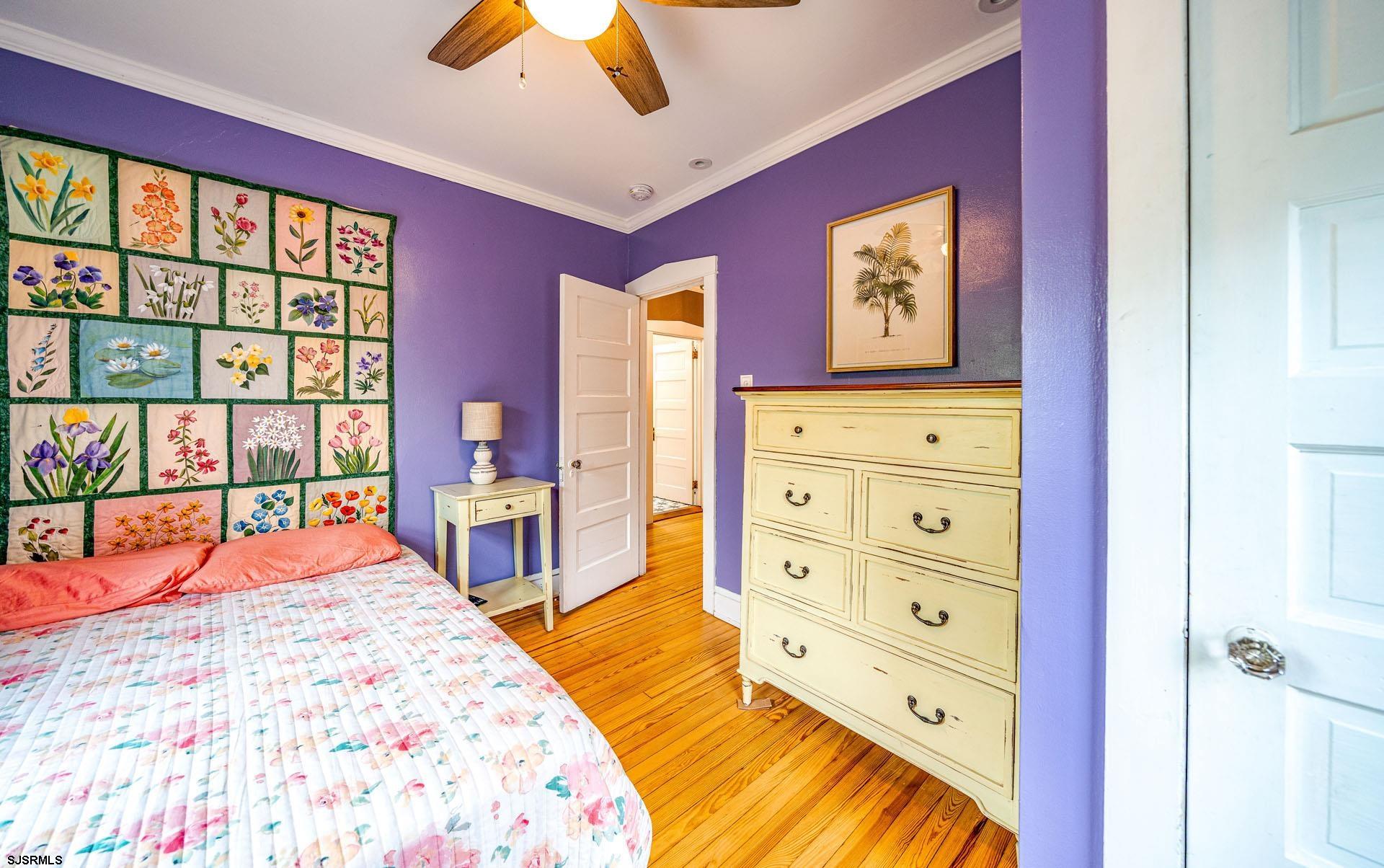 321 Central Avenue Ocean City, NJ 08226 - Photo 18 of 61 a bedroom with a bed dresser and a large window