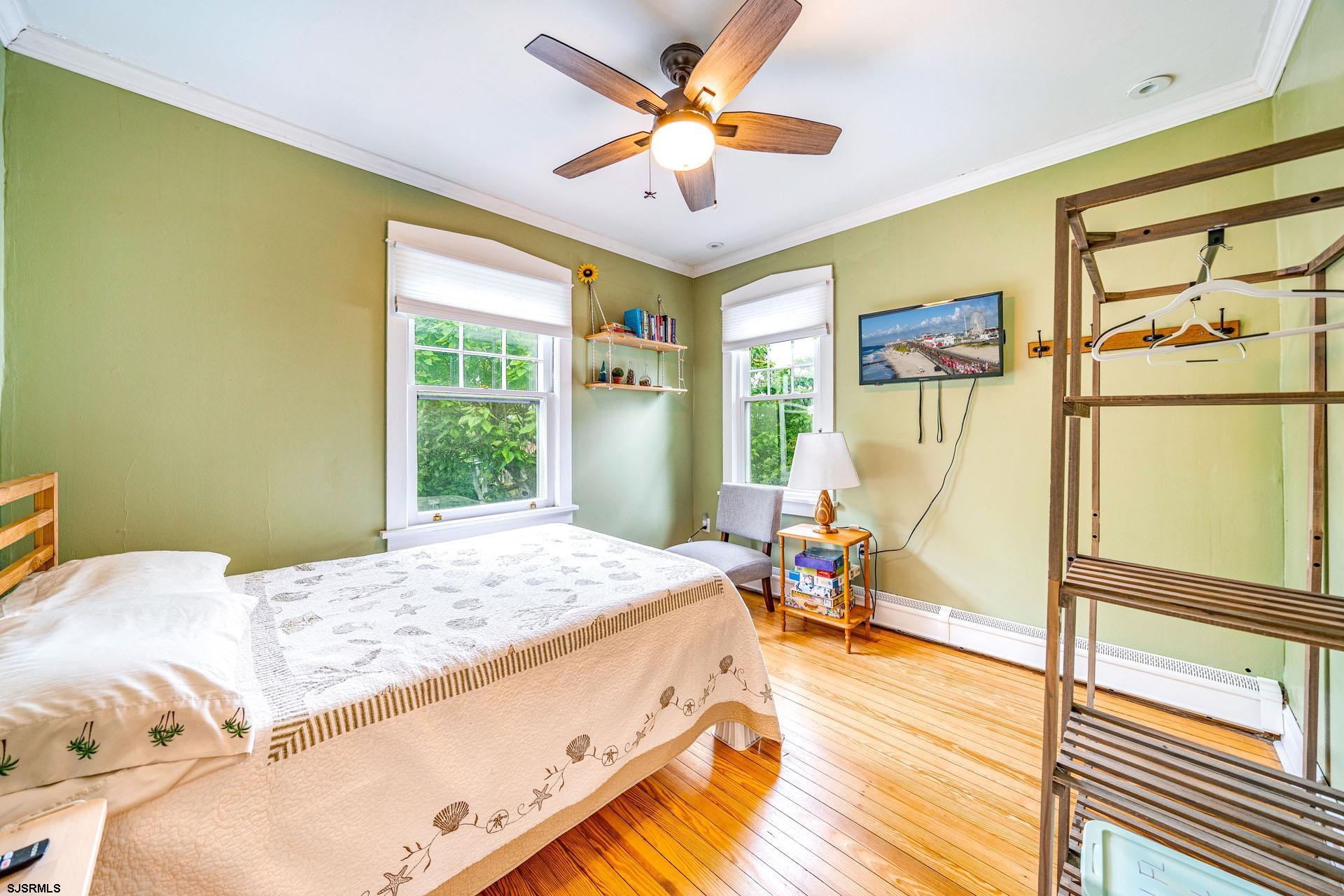 321 Central Avenue Ocean City, NJ 08226 - Photo 20 of 61 a bed sitting in a bedroom next to a window
