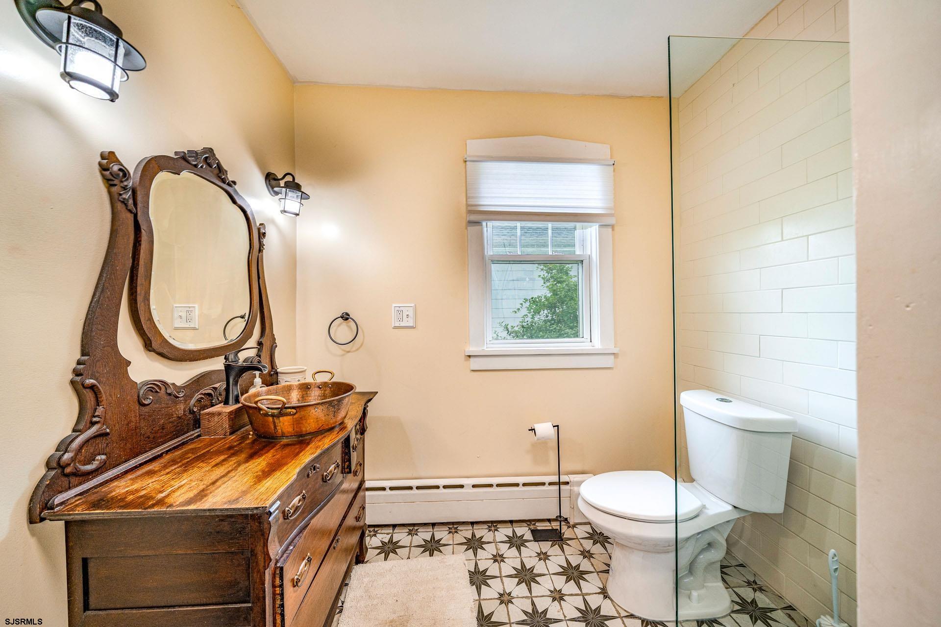 321 Central Avenue Ocean City, NJ 08226 - Photo 21 of 61 a bathroom with a toilet a sink and a mirror