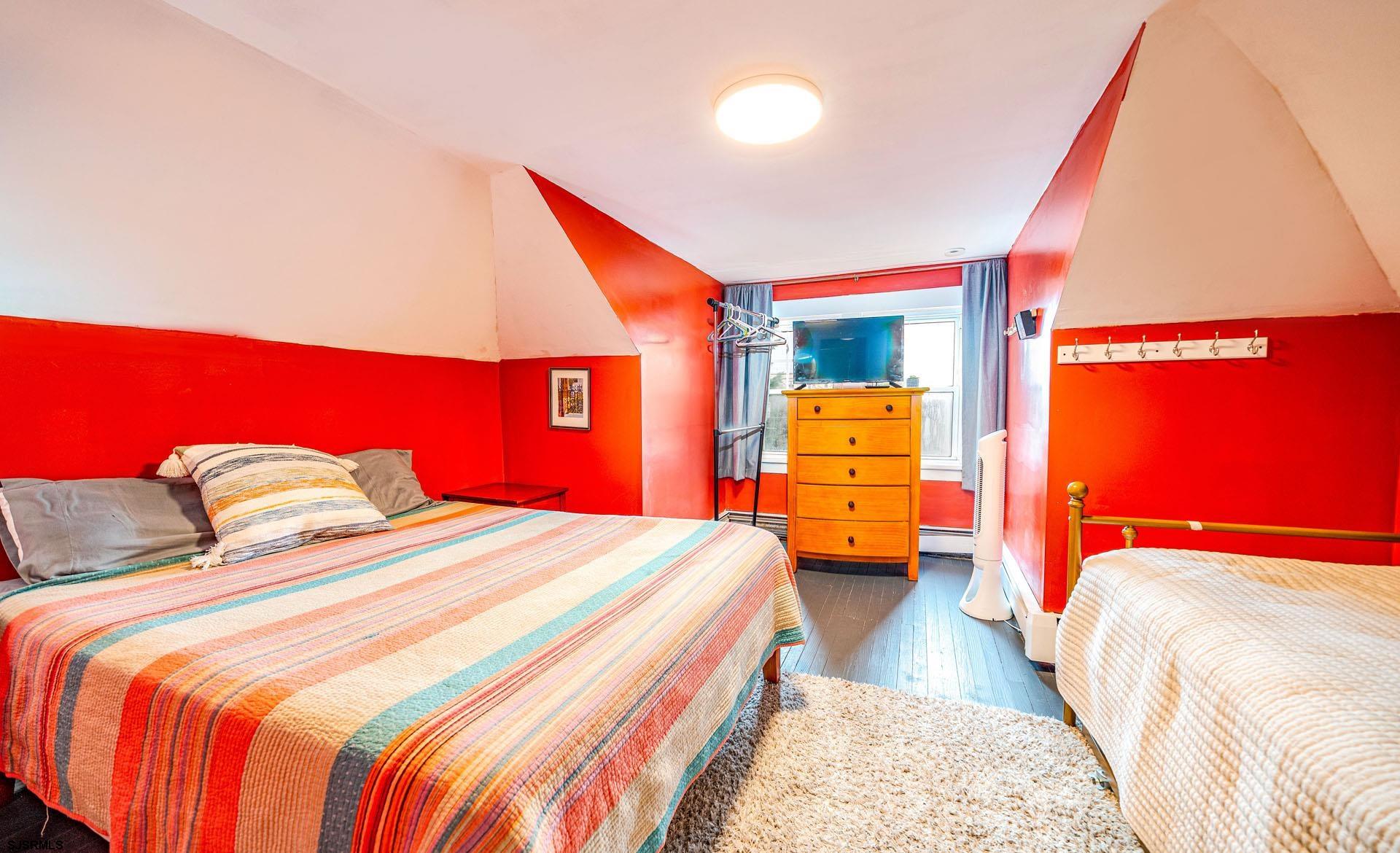 321 Central Avenue Ocean City, NJ 08226 - Photo 32 of 61 a bedroom with a bed and a couch