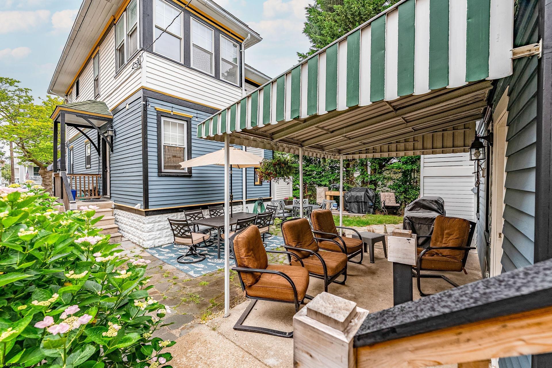 321 Central Avenue Ocean City, NJ 08226 - Photo 35 of 61 a view of a patio with table and chairs and potted plants