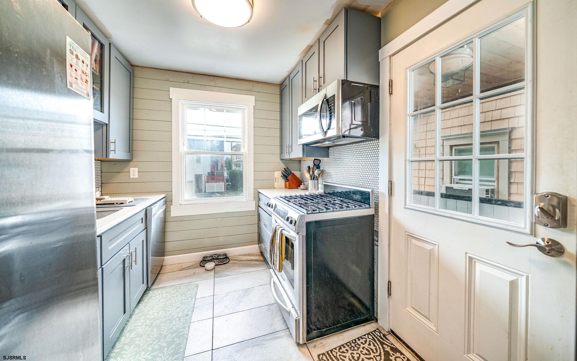321 Central Avenue Ocean City, NJ 08226 - Photo 40 of 61 a kitchen with a sink stove and cabinets