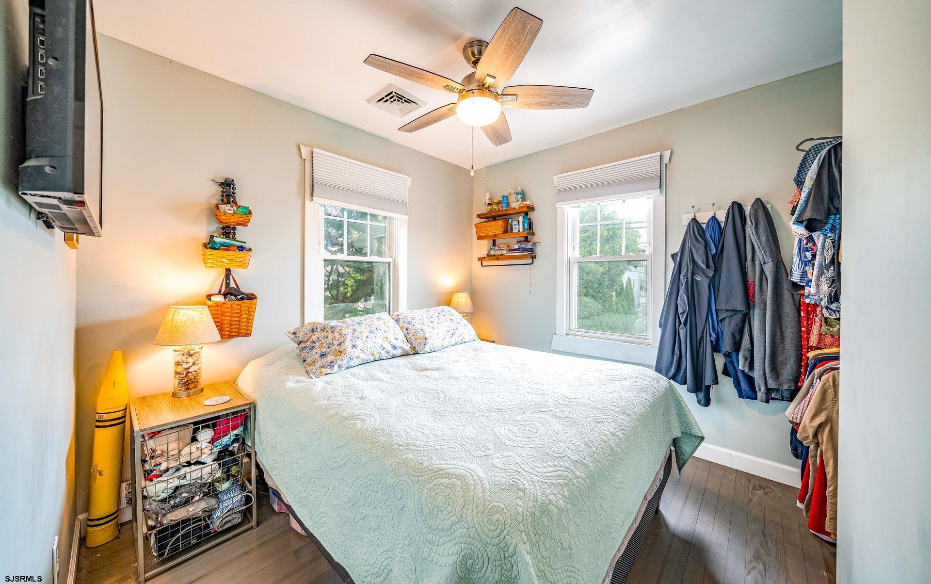 321 Central Avenue Ocean City, NJ 08226 - Photo 44 of 61 a bedroom with a bed and a chandelier