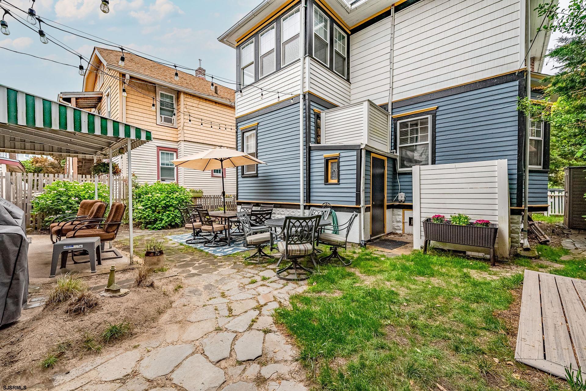 321 Central Avenue Ocean City, NJ 08226 - Photo 57 of 61 a view of a chairs and table in backyard of the house