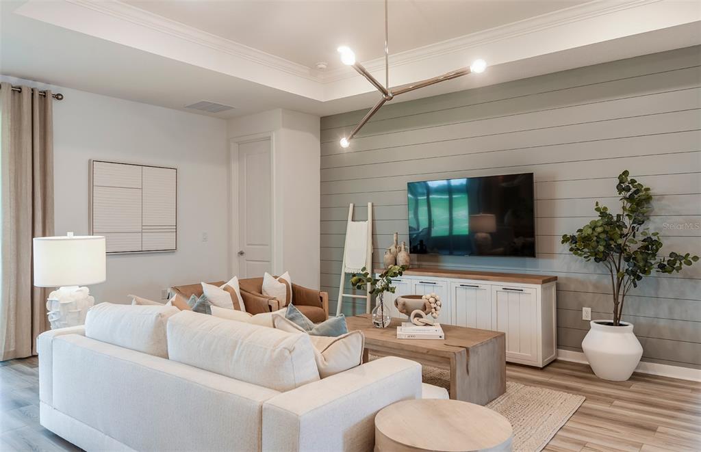 3620 Obsidian Drive Spring Hill, FL 34609 - Photo 7 of 24 a living room with furniture and a flat screen tv