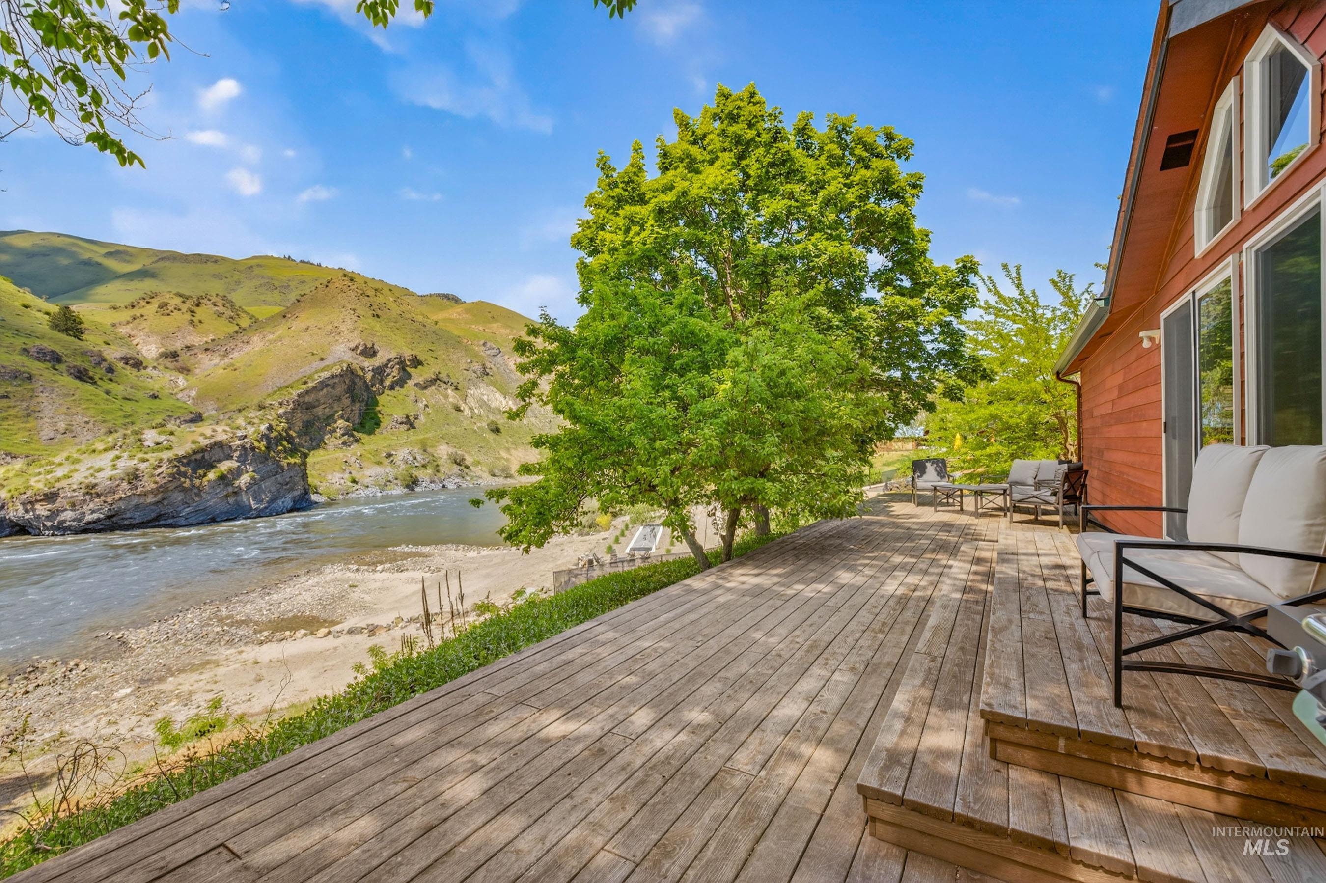 151 Cow Creek Road Lucile, ID 83542 - Photo 37 of 50 Expansive outdoor deck with natural wood planks and built-in steps