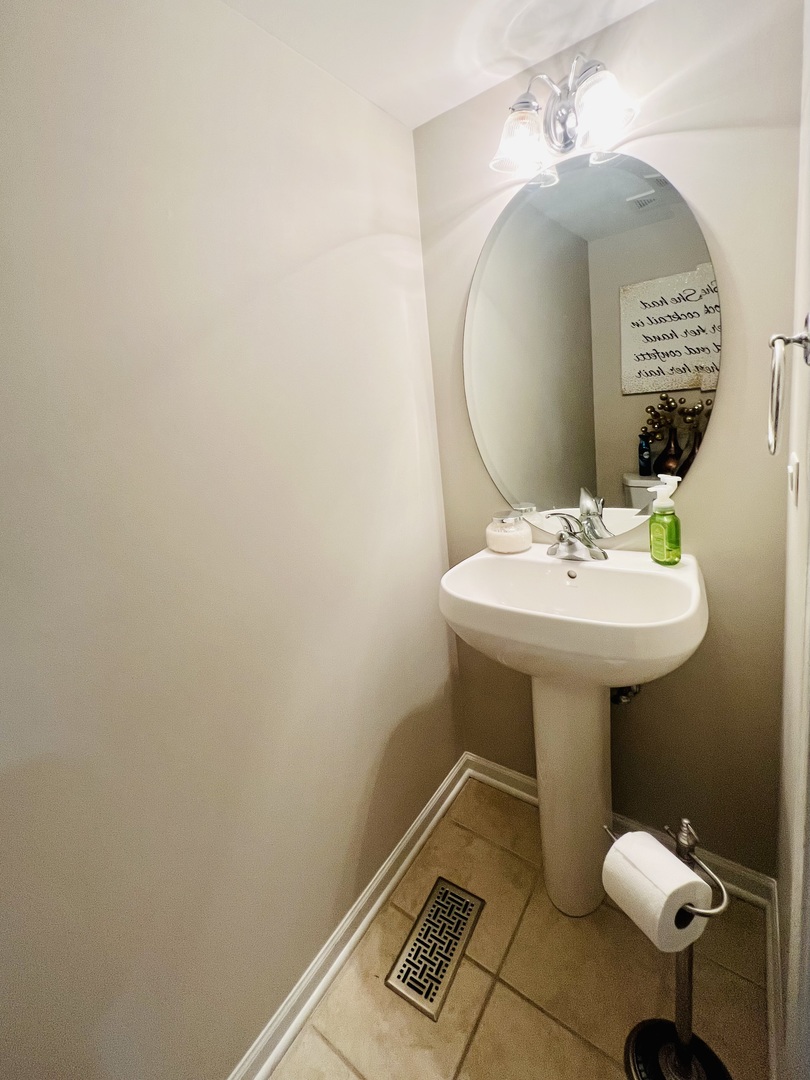 39102 Welsh Lane Beach Park, IL 60083 - Photo 11 of 24 a bathroom with a sink toilet and a mirror