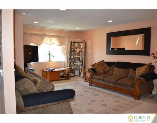 5302 Hana Road Edison, NJ 08817 - Photo 2 of 11 a living room with furniture and a flat screen tv