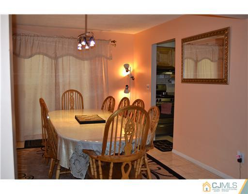 5302 Hana Road Edison, NJ 08817 - Photo 4 of 11 a view of a dining room with furniture and chandelier