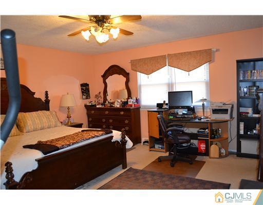 5302 Hana Road Edison, NJ 08817 - Photo 5 of 11 a living room with furniture and a flat screen tv