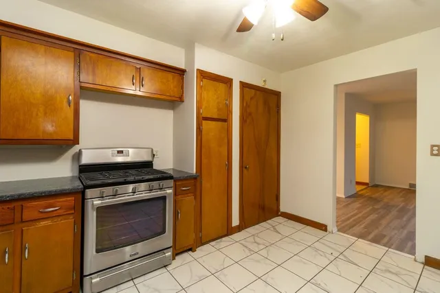 a kitchen with stainless steel appliances granite countertop a stove and a refrigerator