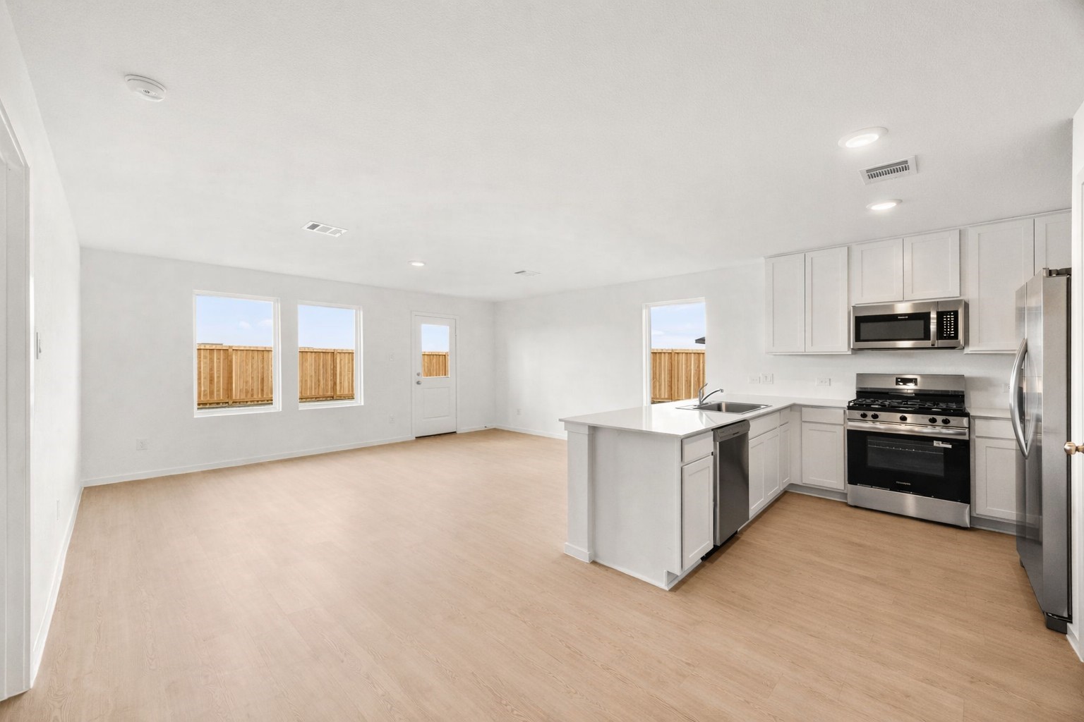 3032 Colusa Rdg Drive Katy, TX 77493 - Photo 6 of 21 a kitchen with a refrigerator and a stove top oven