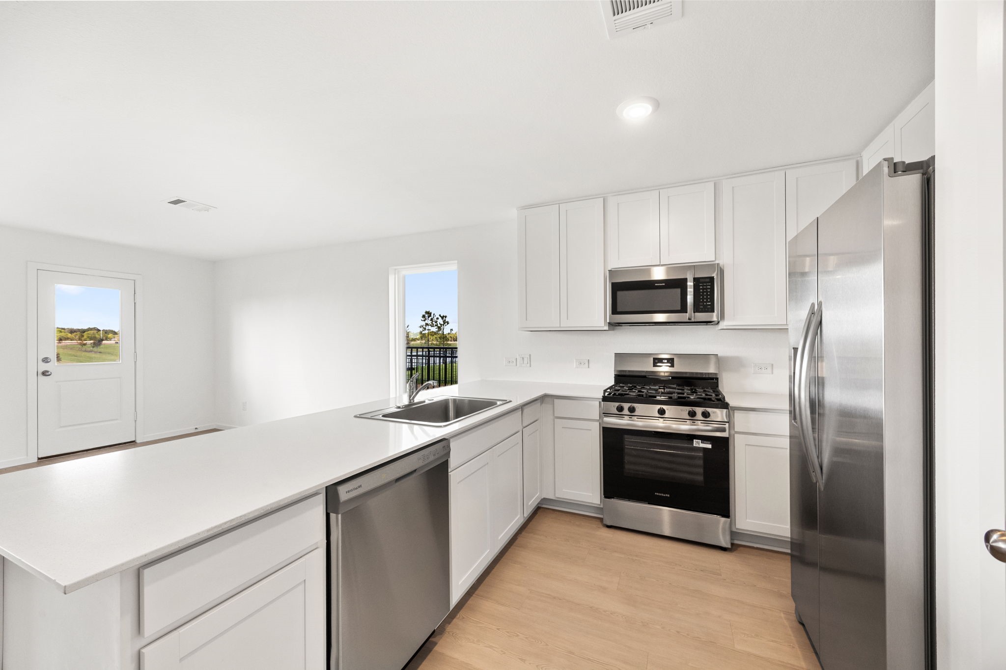 3032 Colusa Rdg Drive Katy, TX 77493 - Photo 7 of 21 a kitchen with a sink stainless steel appliances and white cabinets