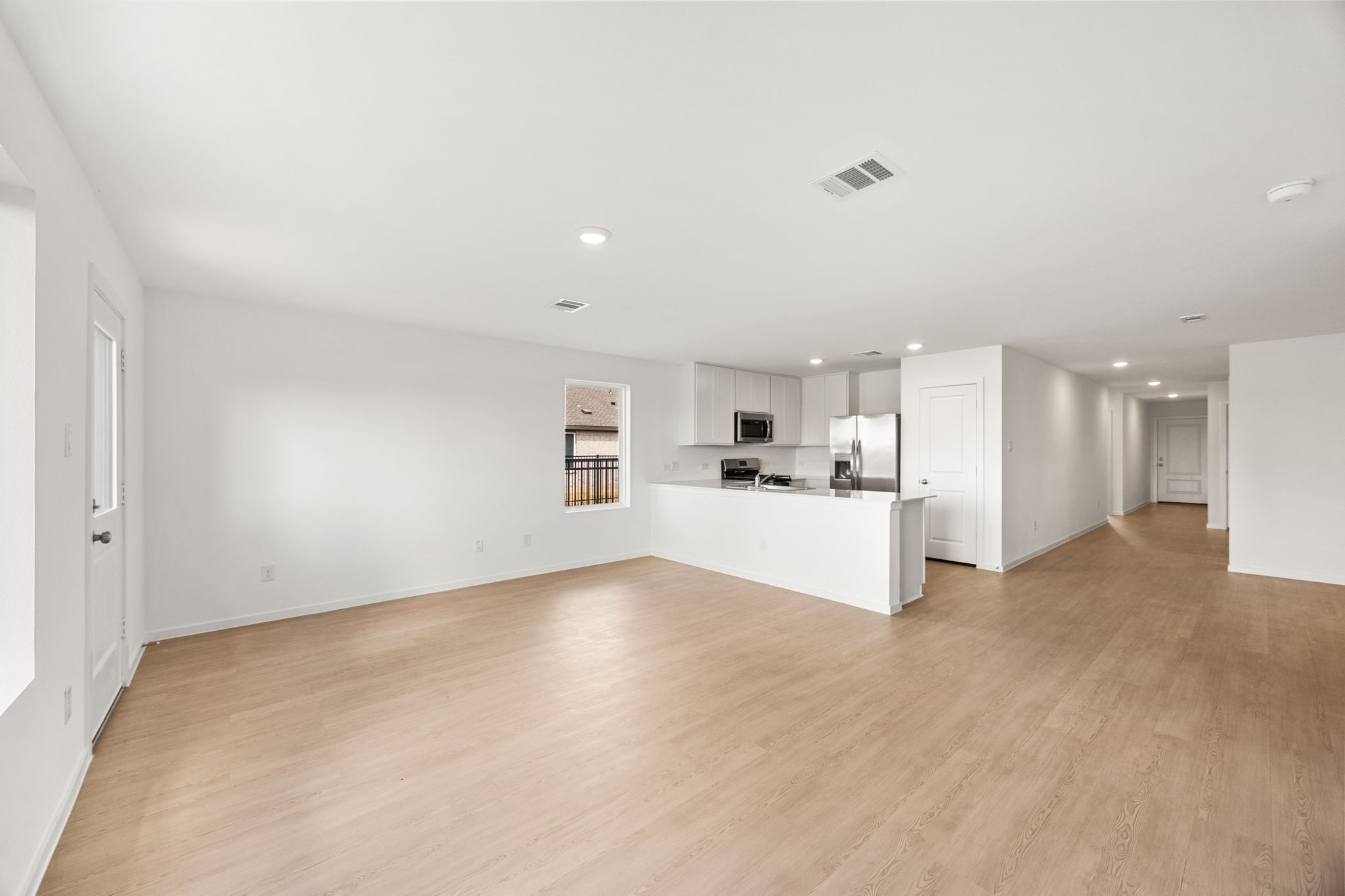 3032 Colusa Rdg Drive Katy, TX 77493 - Photo 8 of 21 a view of a kitchen with refrigerator and white cabinets