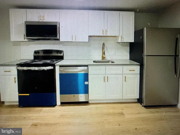 a kitchen with a stove and a refrigerator