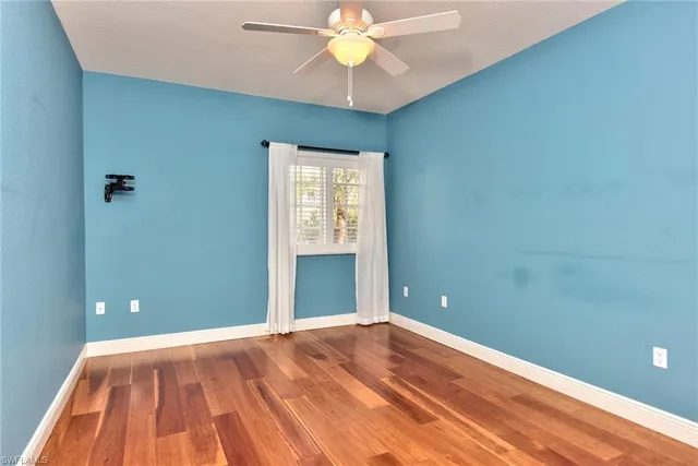 a view of room with window and ceiling fan