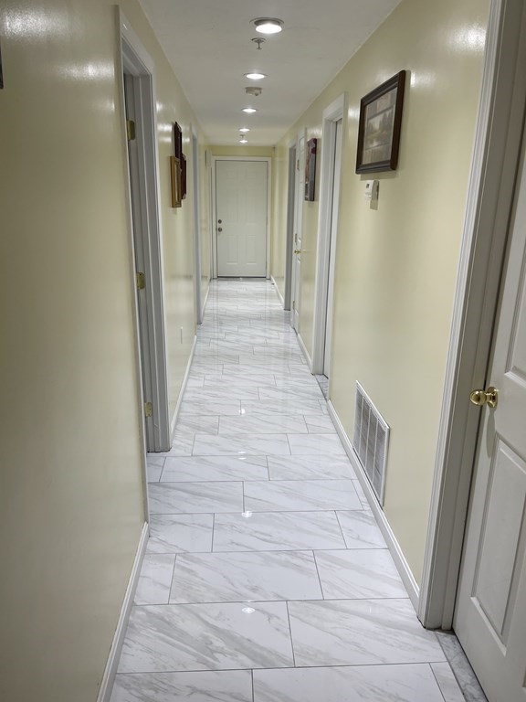 89 West Boylston Street, Unit 3 Worcester, MA 01606 - Photo 4 of 9 a view of a hallway with wooden floor and staircase