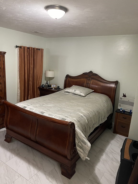 89 West Boylston Street, Unit 3 Worcester, MA 01606 - Photo 7 of 9 a bedroom with a bed and window