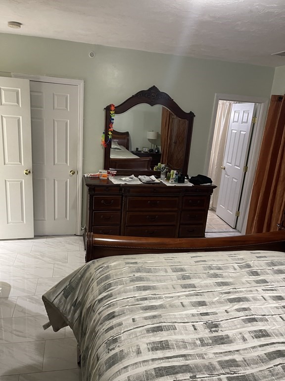 89 West Boylston Street, Unit 3 Worcester, MA 01606 - Photo 8 of 9 a bed sitting in a bedroom and dresser