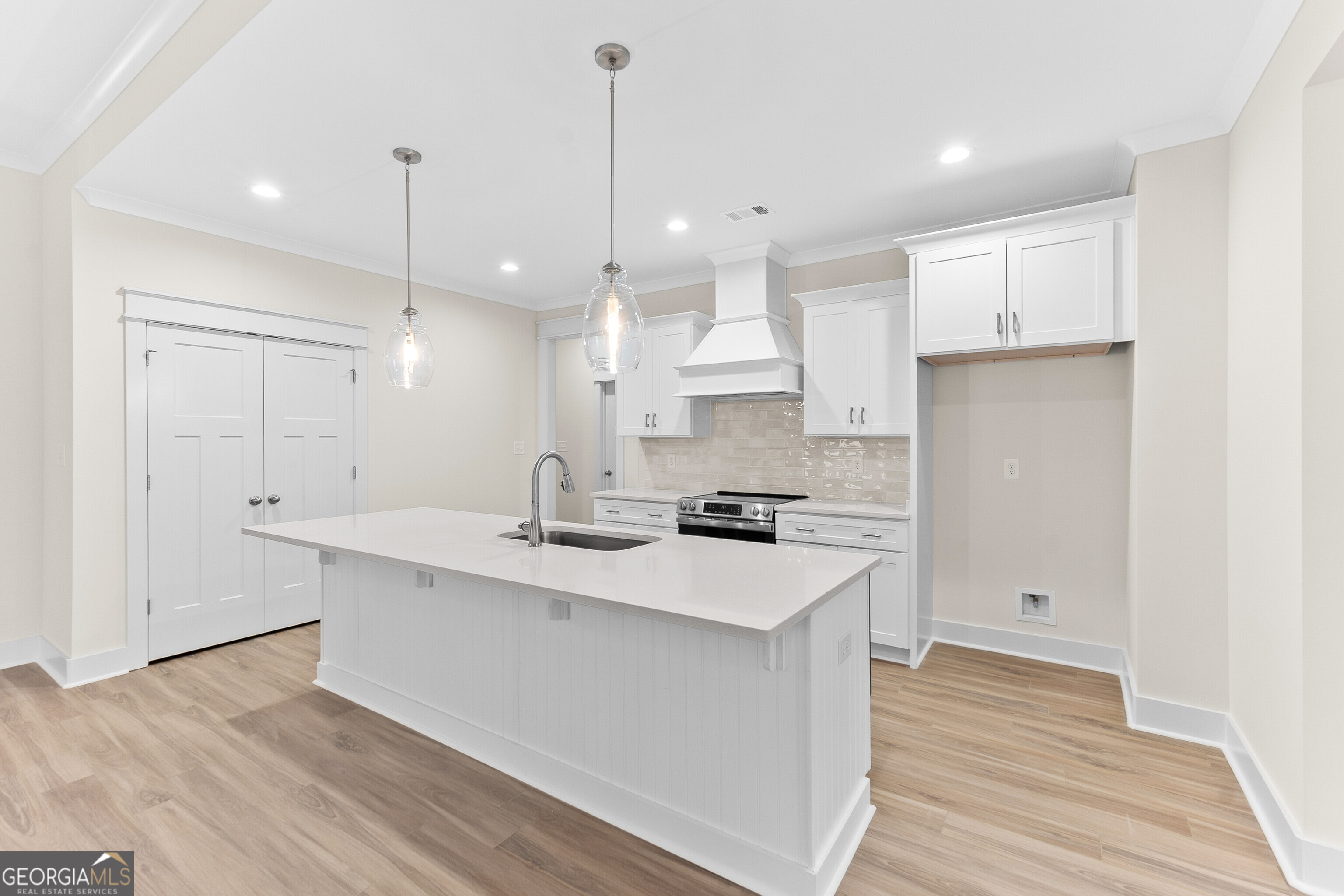 608 Bristleleaf Path Kathleen, GA 31047 - Photo 12 of 48 a kitchen with a sink a stove a refrigerator and white cabinets