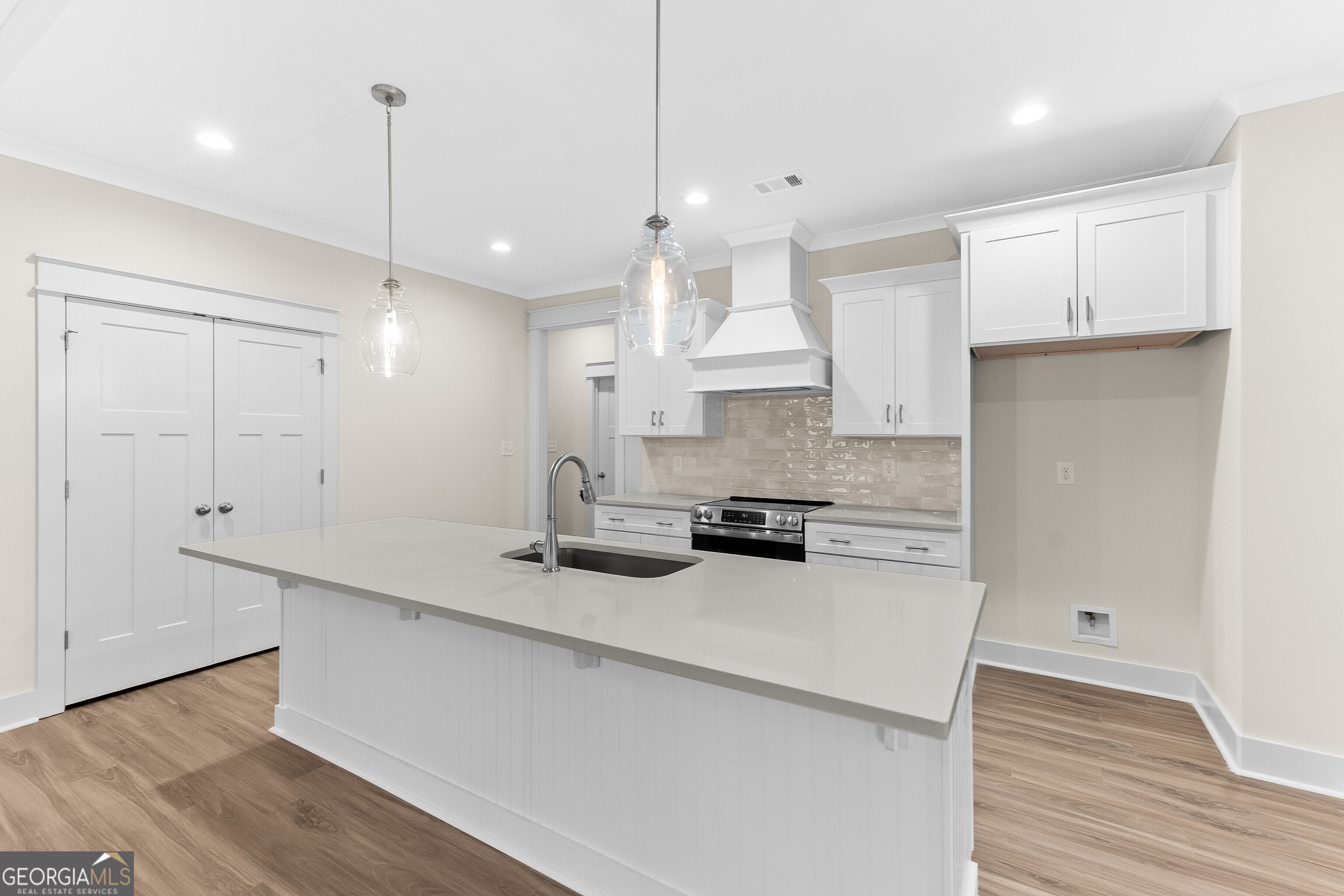 608 Bristleleaf Path Kathleen, GA 31047 - Photo 13 of 48 a kitchen with kitchen island a stove a counter space and a refrigerator