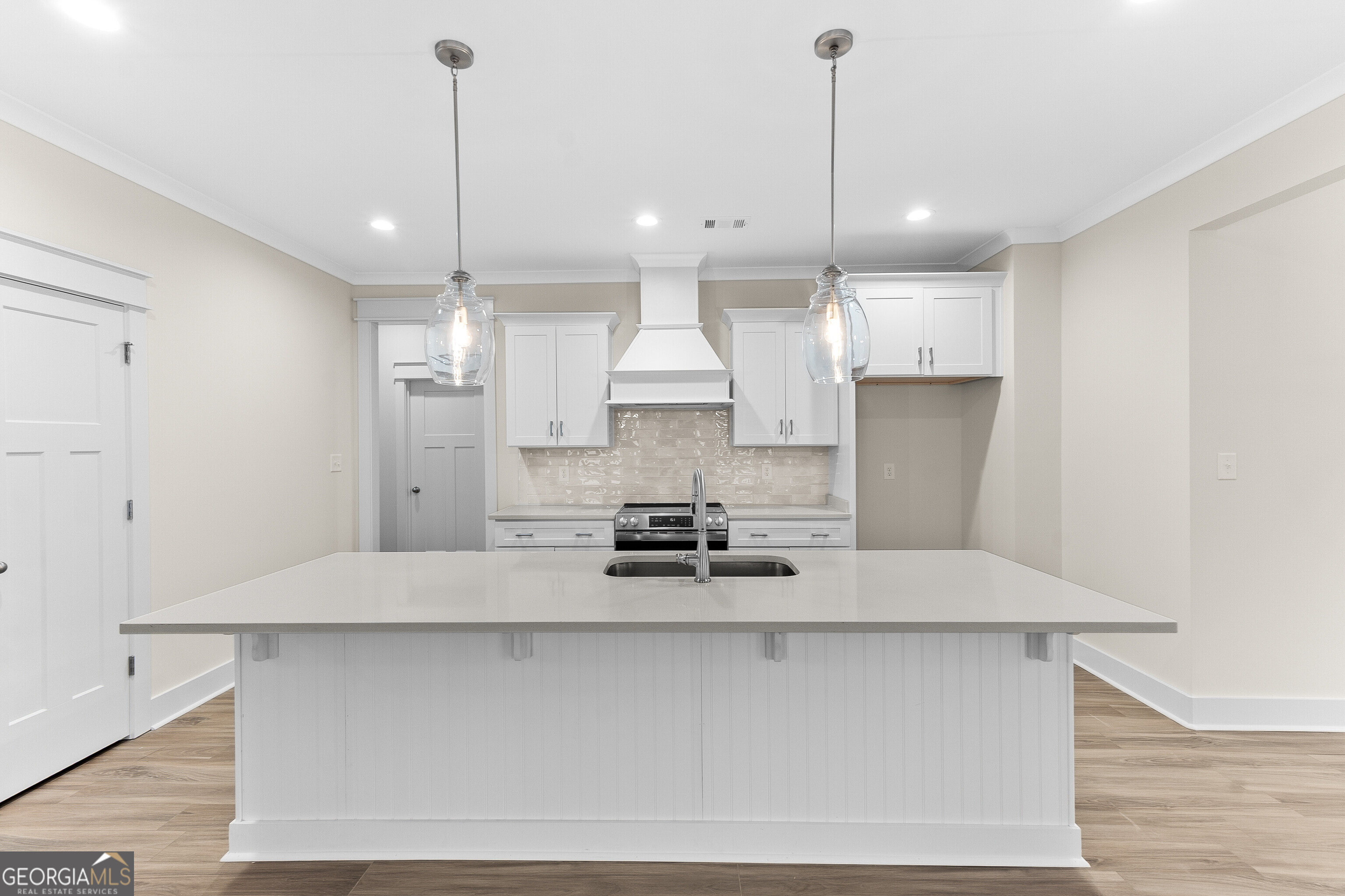 608 Bristleleaf Path Kathleen, GA 31047 - Photo 14 of 48 a kitchen with kitchen island a stove a refrigerator a sink and a counter top space