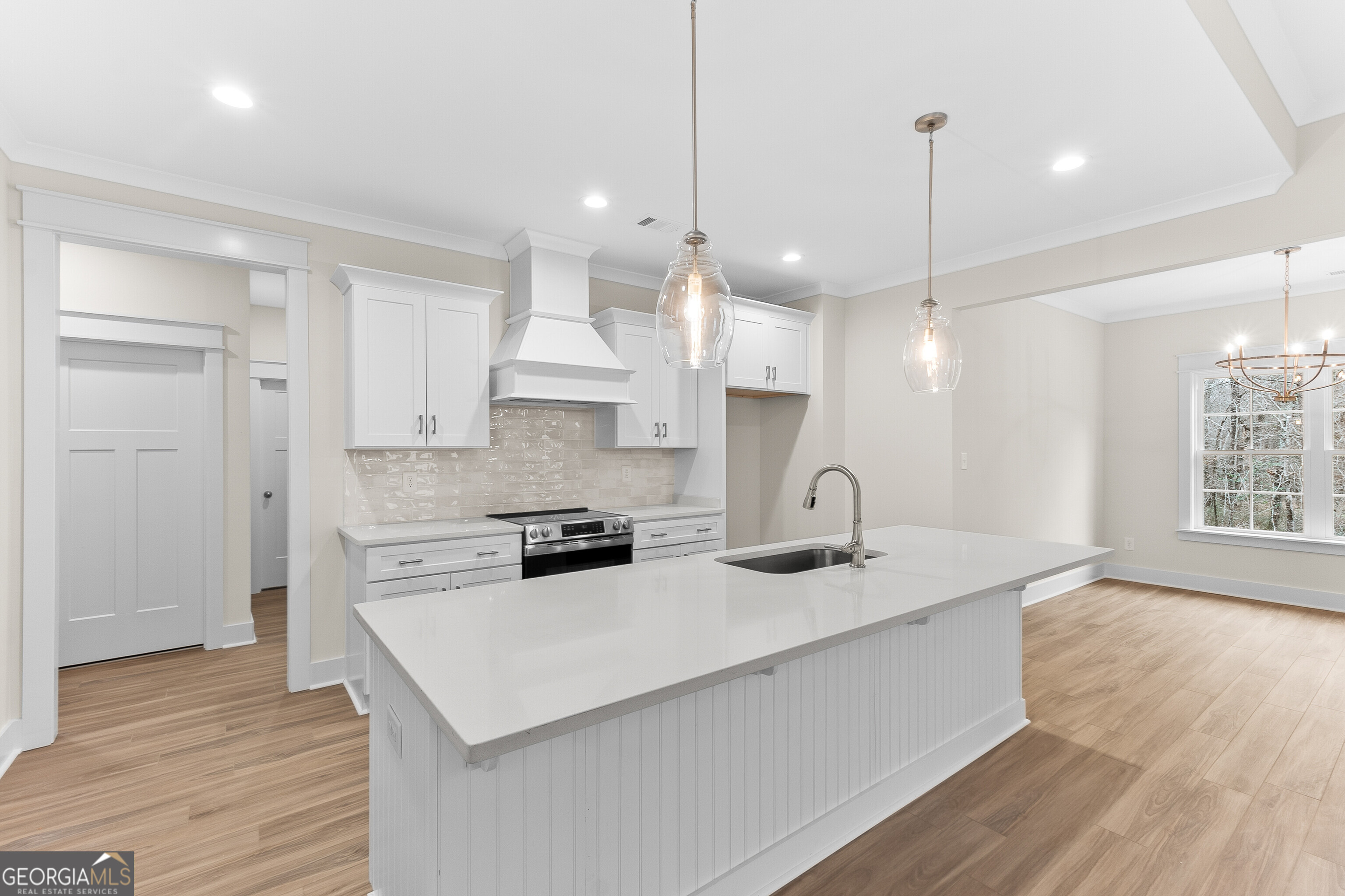 608 Bristleleaf Path Kathleen, GA 31047 - Photo 15 of 48 a kitchen with stainless steel appliances granite countertop a sink a stove a refrigerator cabinets and wooden floor