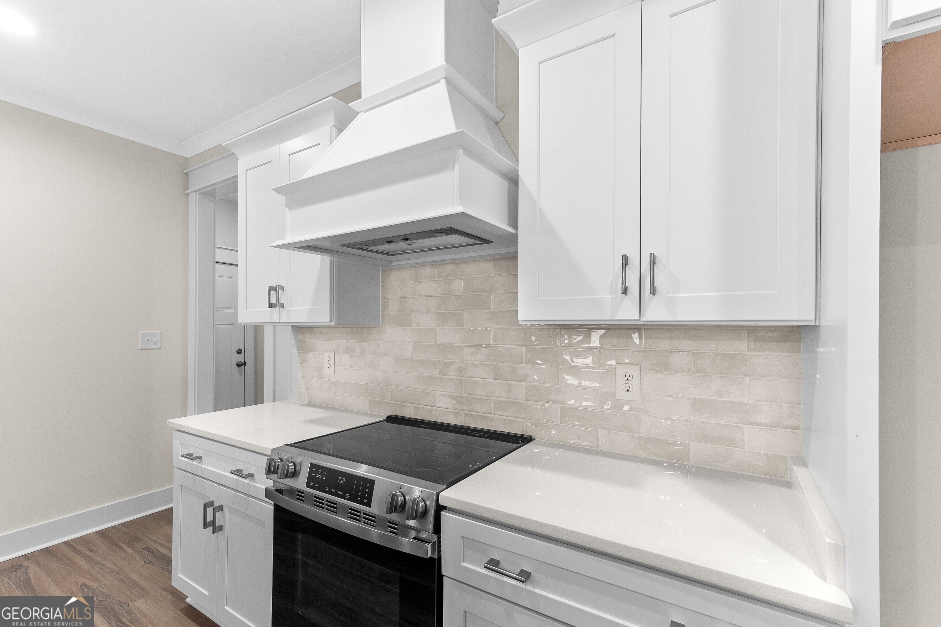 608 Bristleleaf Path Kathleen, GA 31047 - Photo 18 of 48 a kitchen with white cabinets and white appliances