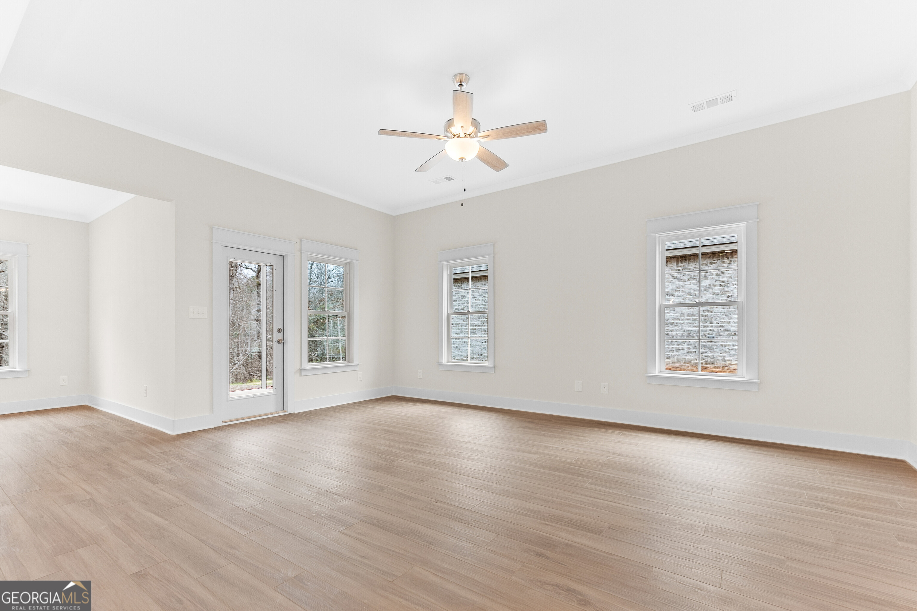 608 Bristleleaf Path Kathleen, GA 31047 - Photo 7 of 48 a view of an empty room with wooden floor and a ceiling fan