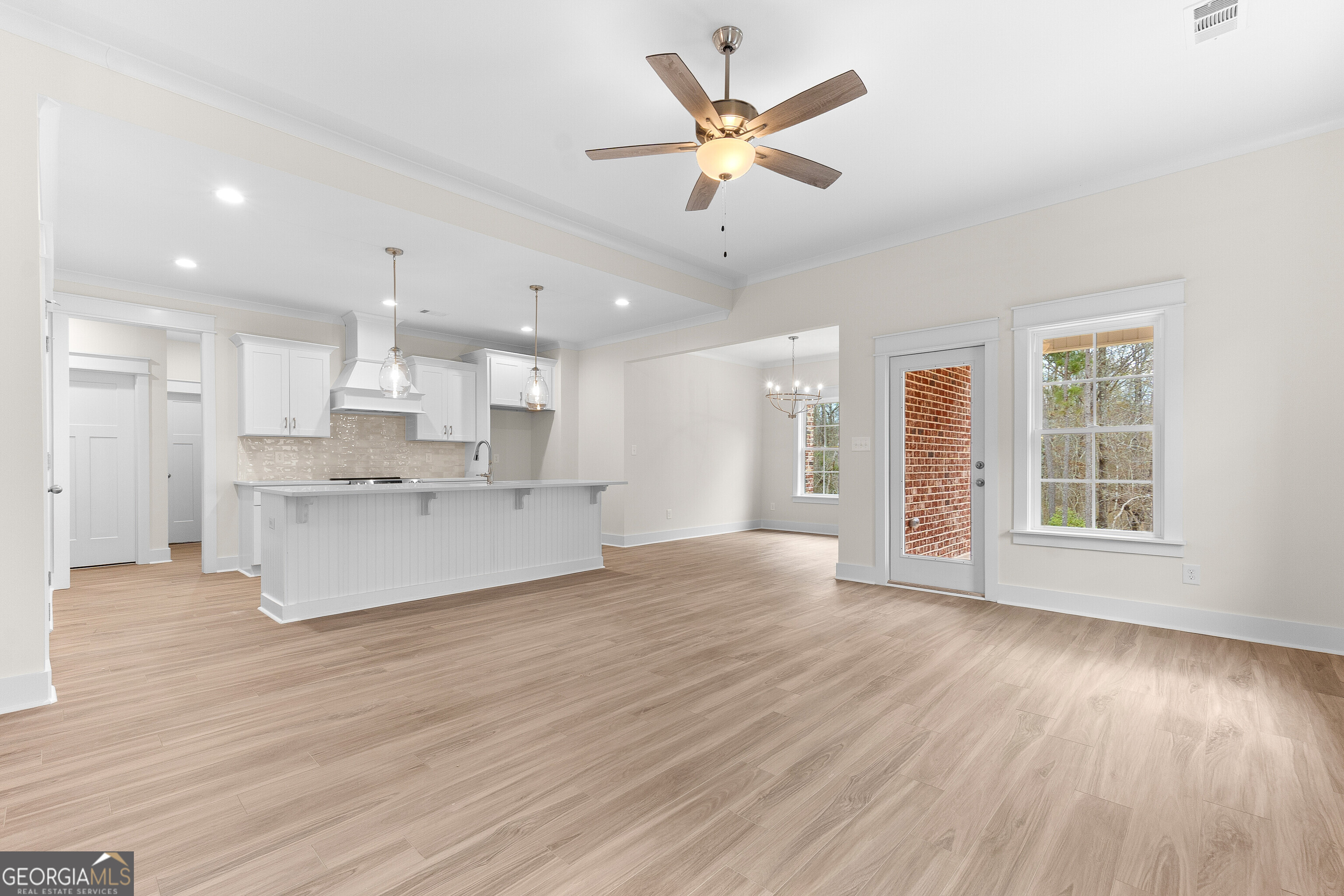 608 Bristleleaf Path Kathleen, GA 31047 - Photo 9 of 48 a view of an empty room and kitchen with wooden floor