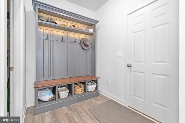a dining room with furniture wooden floor and a potted plant