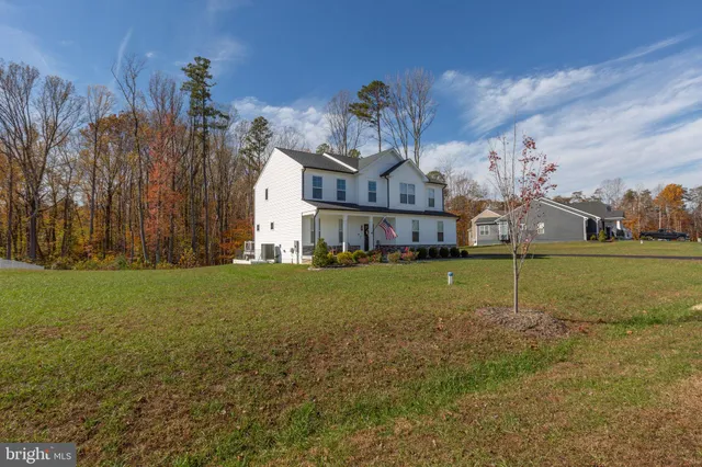 a view of a patio with table and chairs and wooden fence