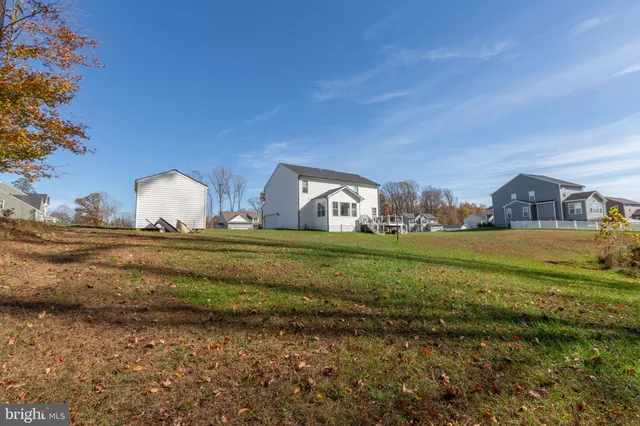 a view of a swimming pool with a garden and trees