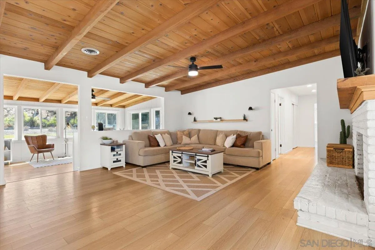 13509 East Lakeview Road Lakeside, CA 92040 - Photo 14 of 43 a spacious bedroom with a bed a couch and a large window