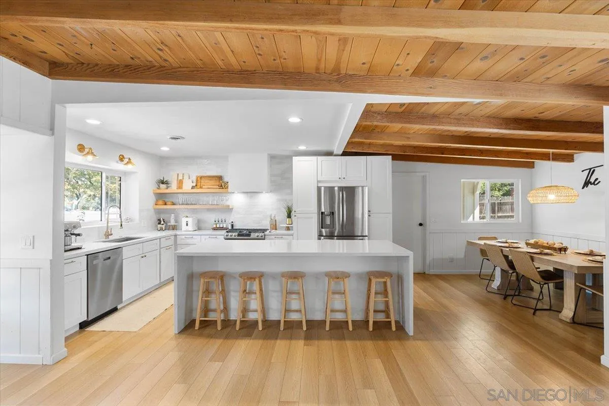 13509 East Lakeview Road Lakeside, CA 92040 - Photo 3 of 43 a kitchen with stainless steel appliances granite countertop a kitchen island hardwood floor and a sink