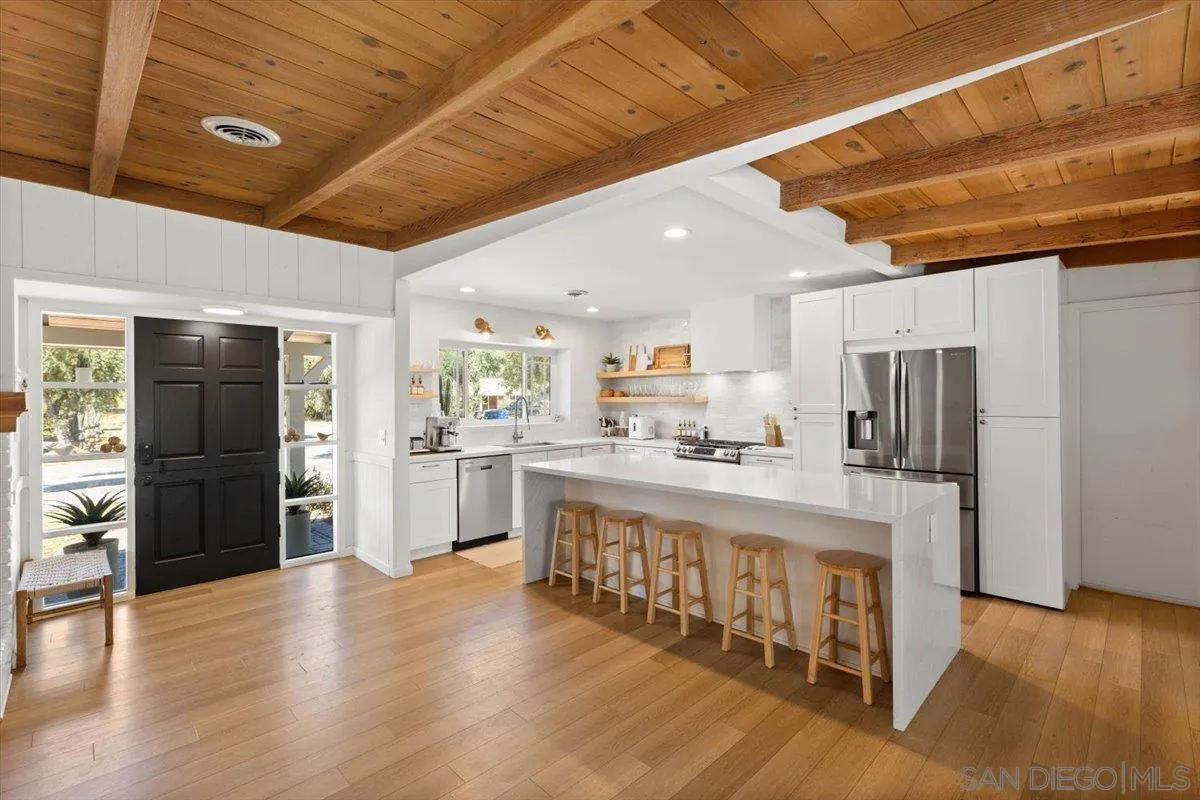 13509 East Lakeview Road Lakeside, CA 92040 - Photo 8 of 43 a large white kitchen with stainless steel appliances granite countertop a refrigerator and a stove
