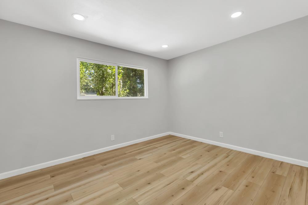 8843 Pershing Avenue Orangevale, CA 95662 - Photo 17 of 29 an empty room with wooden floor and windows