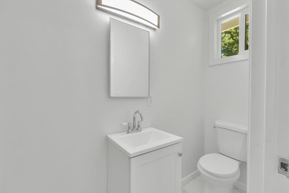 8843 Pershing Avenue Orangevale, CA 95662 - Photo 19 of 29 a bathroom with a toilet a sink and mirror