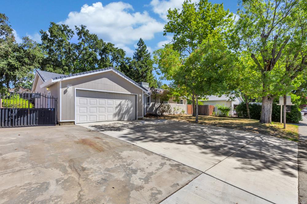 8843 Pershing Avenue Orangevale, CA 95662 - Photo 26 of 29 a view of a house with a yard and garage