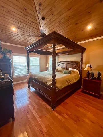 a bedroom with bed and window