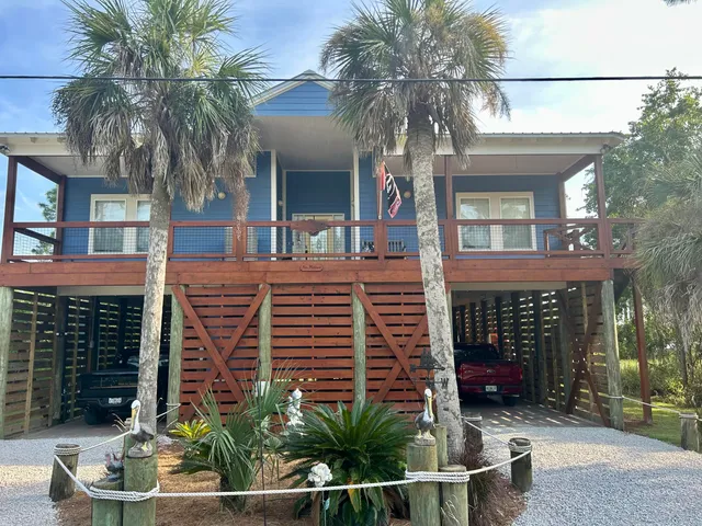 a view of a house with a small yard and plants
