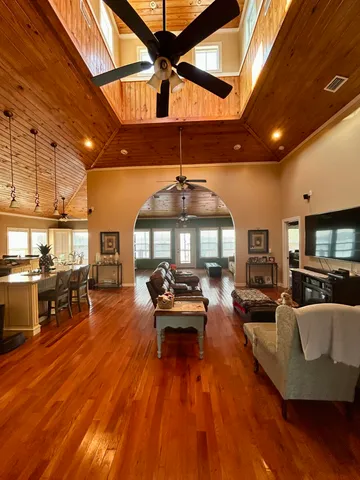 a living room with furniture and a wooden floor