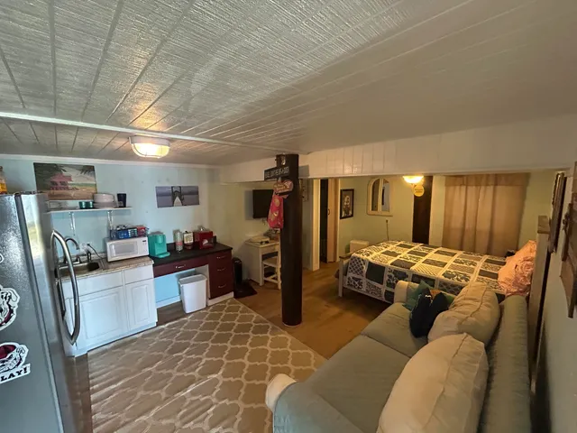 a living room with stainless steel appliances kitchen island granite countertop furniture and a kitchen view