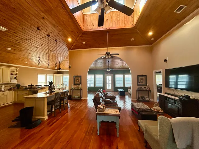 a living room with lots of furniture and a flat screen tv