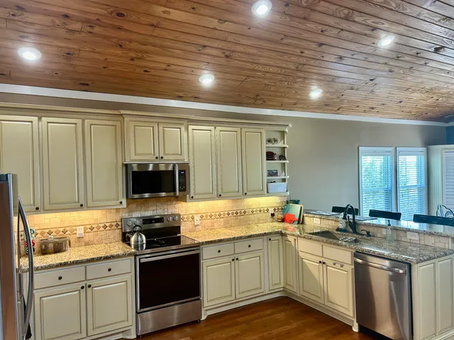 a kitchen with stainless steel appliances granite countertop a stove and a sink